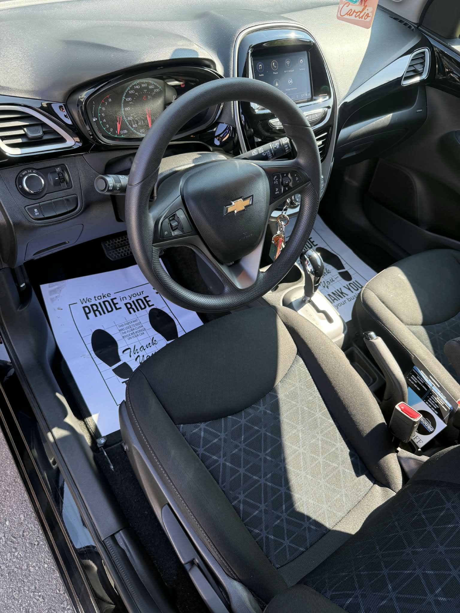 Chevrolet compact car front seat, steering wheel, and manual gear shift
