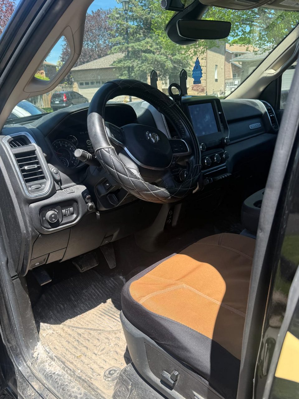 Ram pickup interior before detailing: dirt-caked floor and seat cover