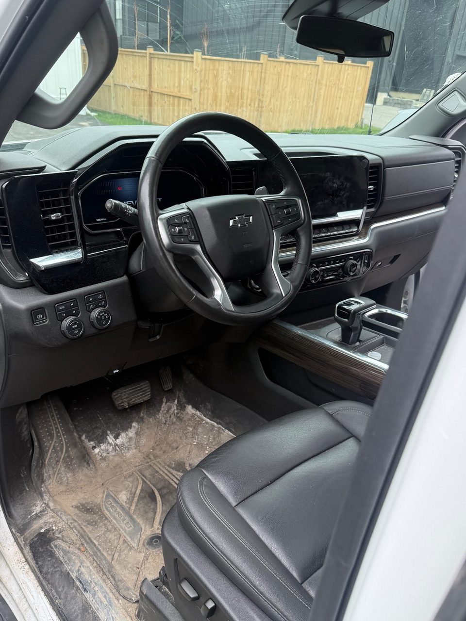 Chevrolet Silverado interior before detailing: mud and salt covering the floor